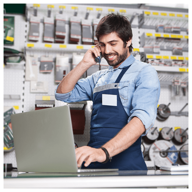 Male employee stood a trade counter on the phone